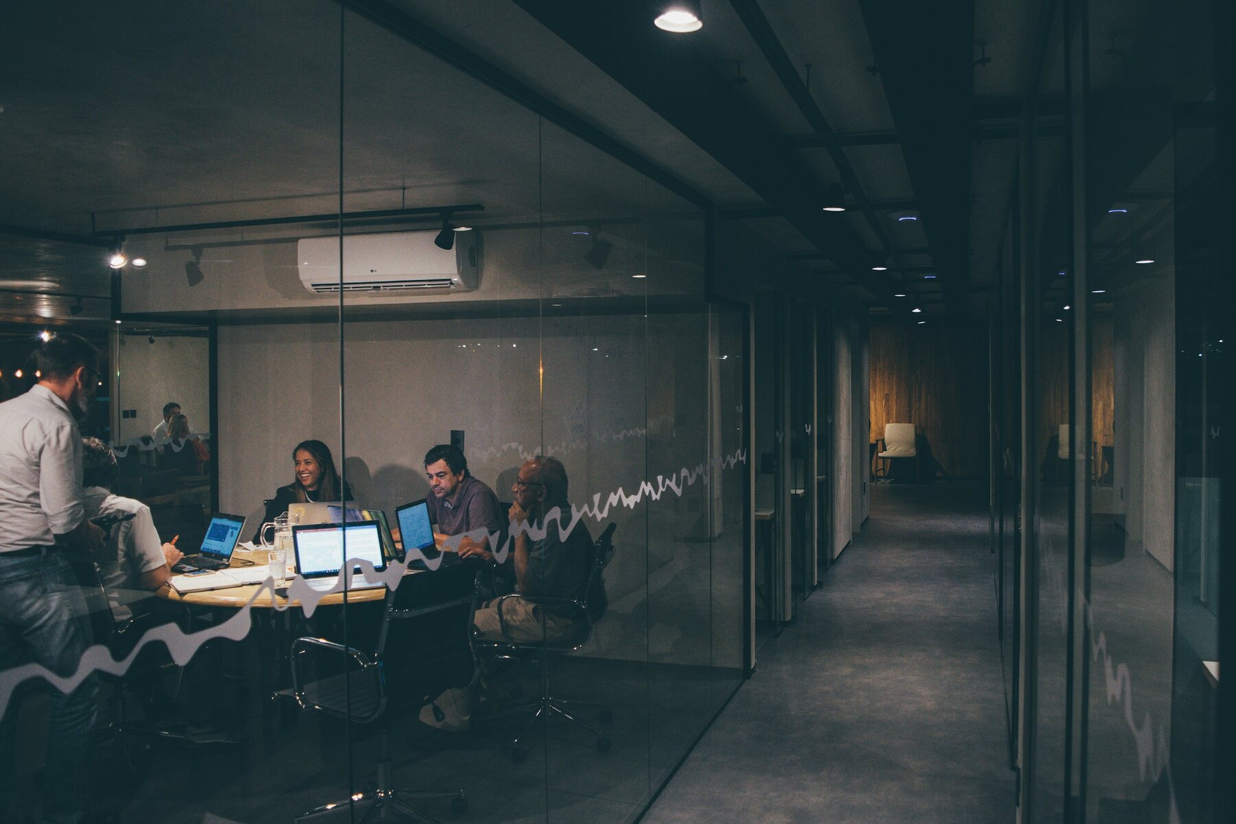 A team meeting in a glass-walled office